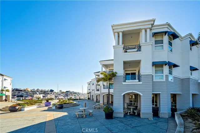 a city view with tall buildings and cars parked on road