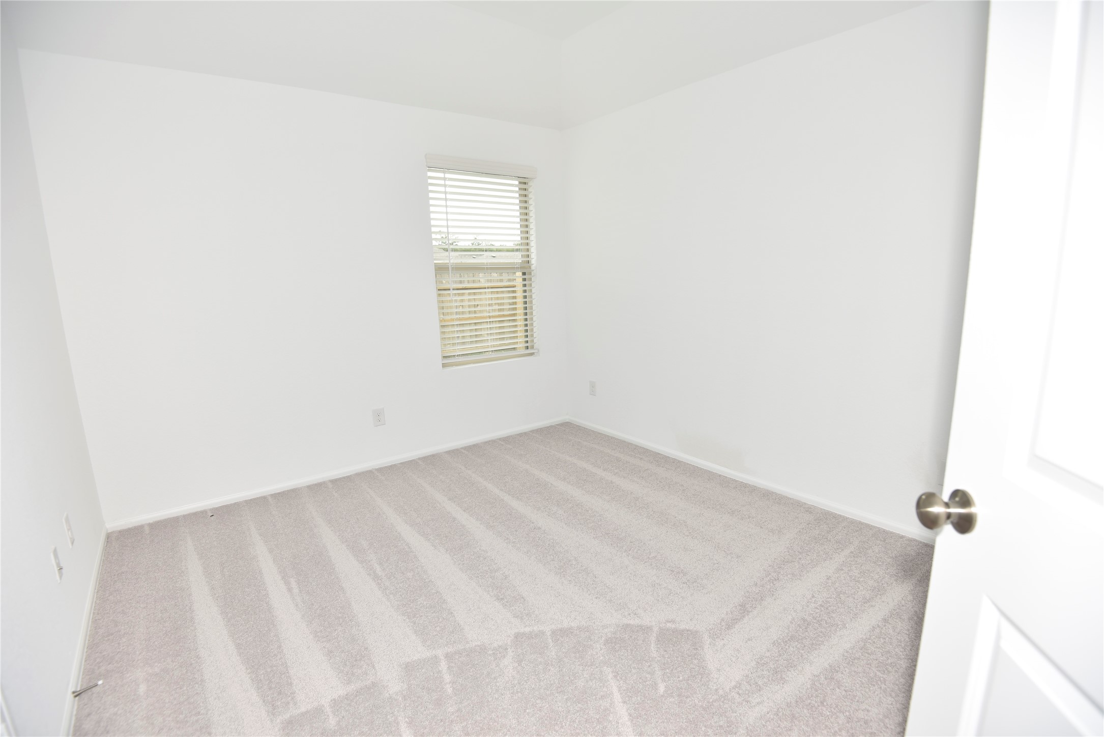 21562 Casavatore Drive New Caney, TX 77357 - Photo 13 of 24 a view of an empty room with a window
