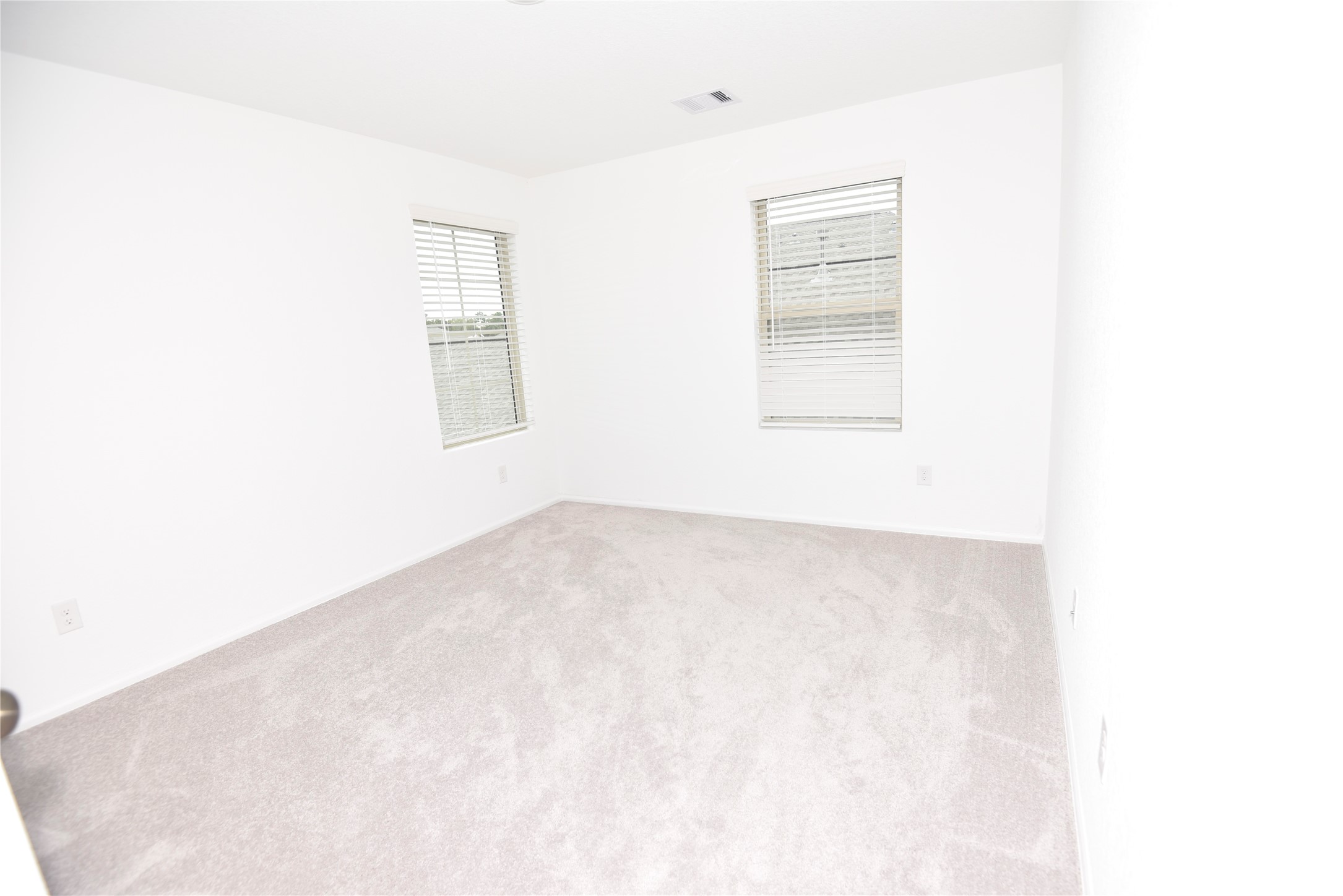 21562 Casavatore Drive New Caney, TX 77357 - Photo 19 of 24 a view of empty room with windows