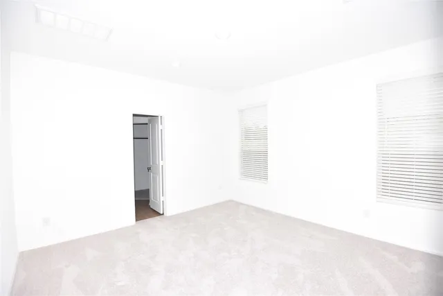 a view of a house with a big yard and large trees