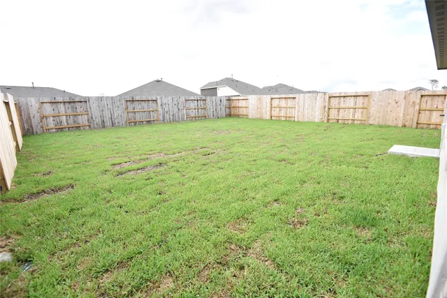 a large house with a big yard and large tree