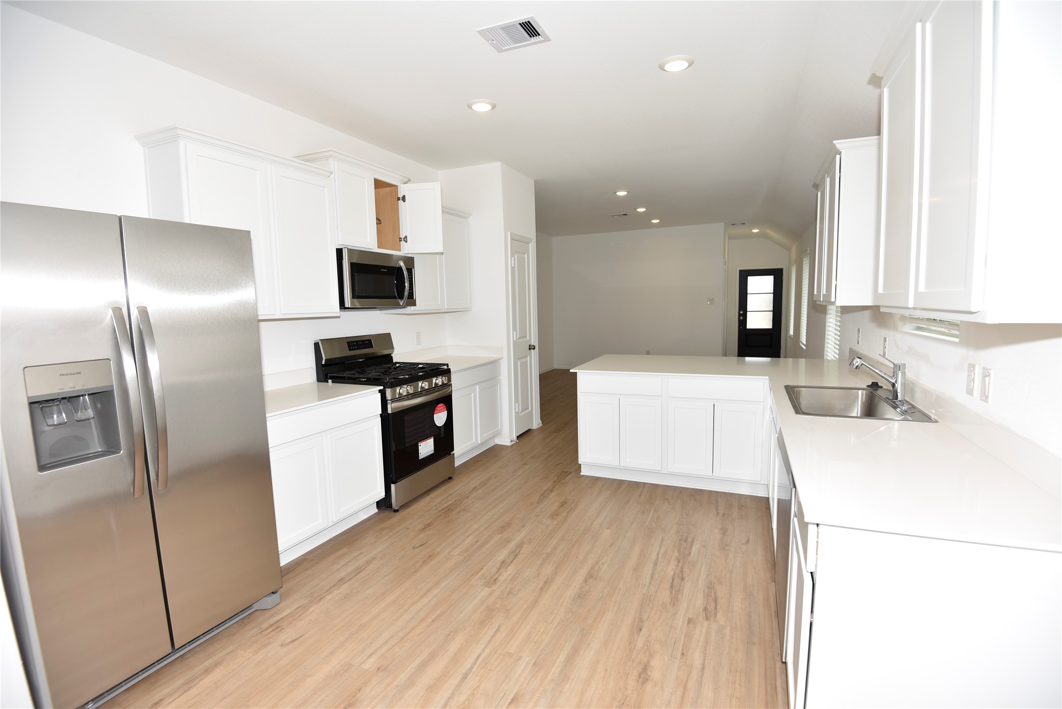 21562 Casavatore Drive New Caney, TX 77357 - Photo 7 of 24 a kitchen with a refrigerator and a sink