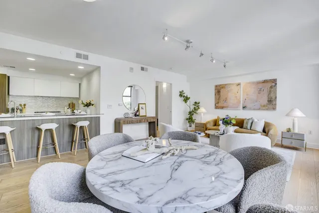 a living room with furniture a dining table and kitchen view
