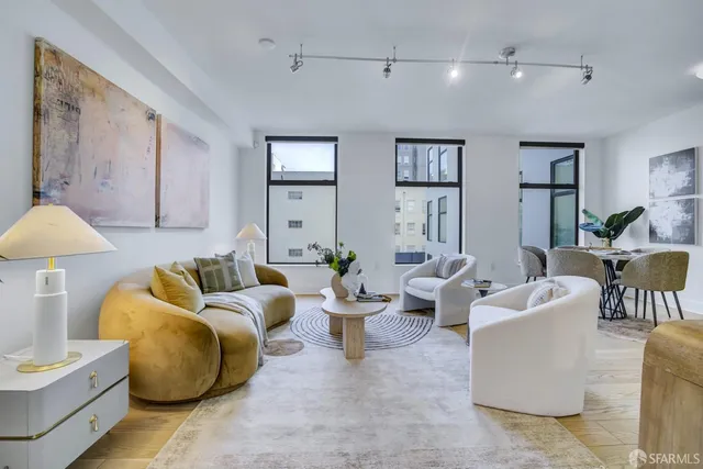 a living room with furniture and white walls