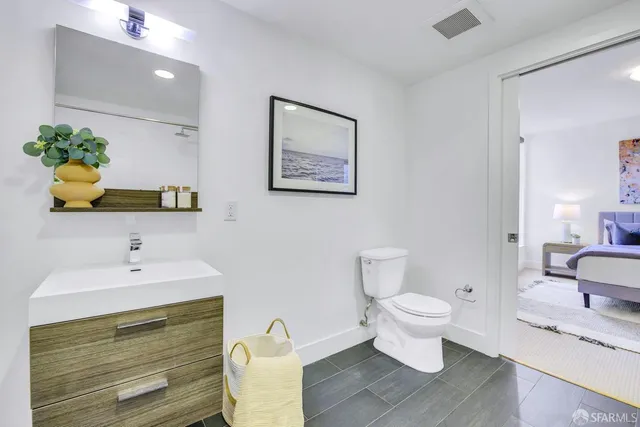 a bathroom with a toilet sink and mirror