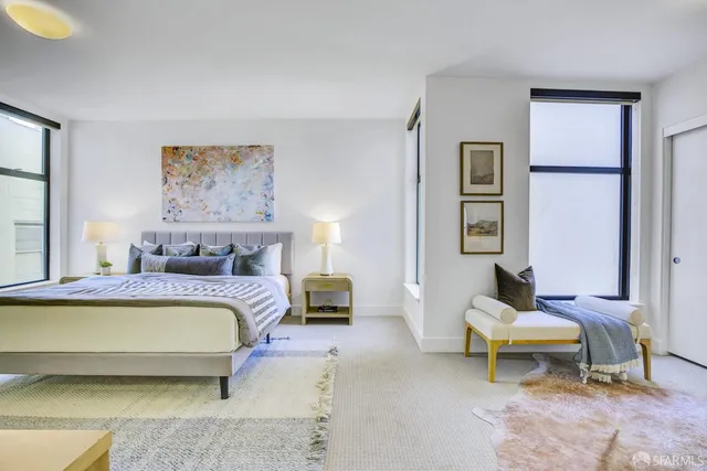 a bedroom with a bed and a couch