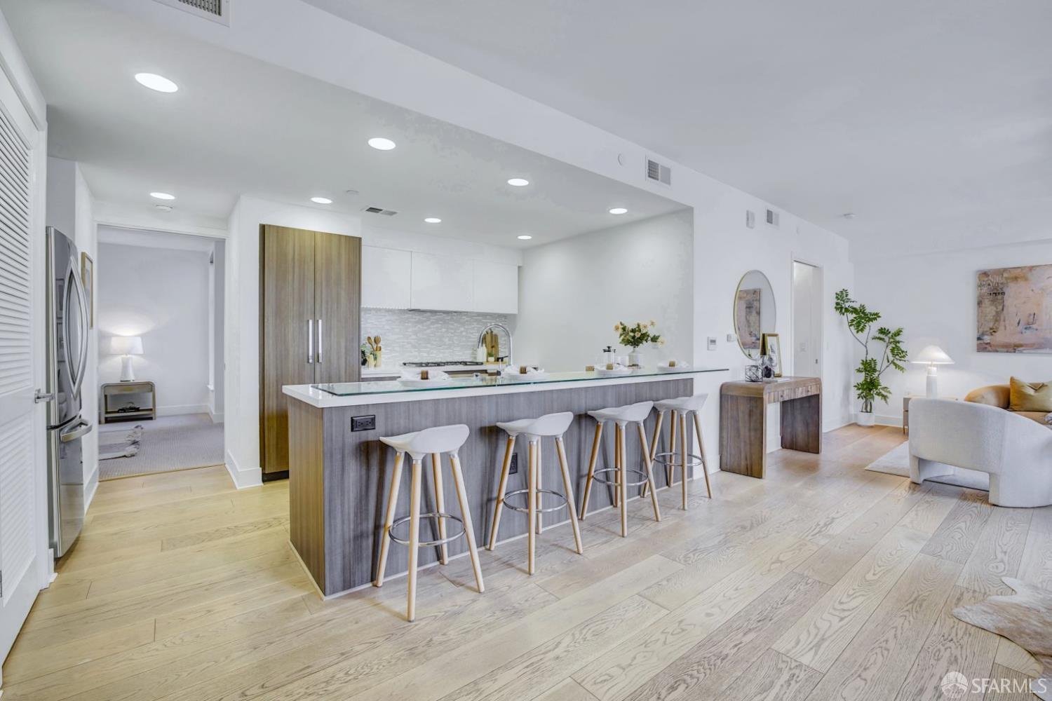 1080 Sutter Street, Unit 702 San Francisco, CA 94109 - Photo 7 of 27 a kitchen with kitchen island granite countertop a sink and refrigerator
