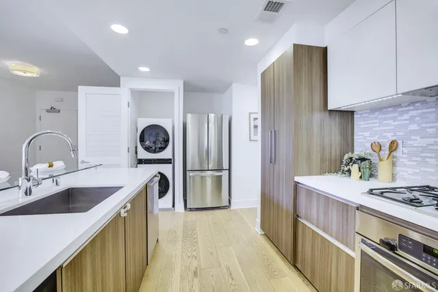 a kitchen with a sink stove and refrigerator