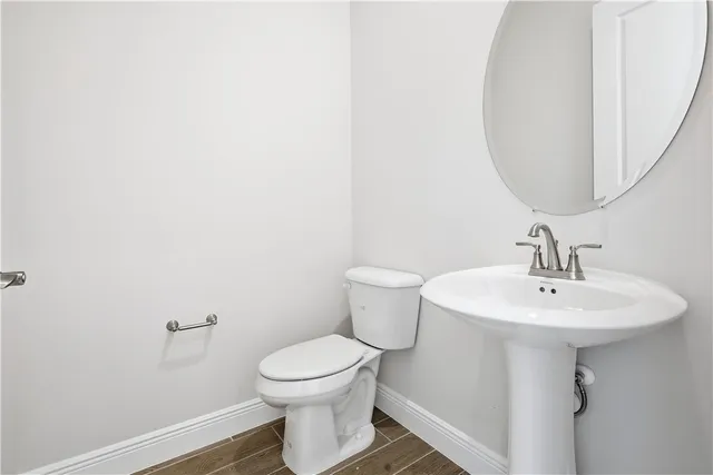 a bathroom with a sink toilet and mirror