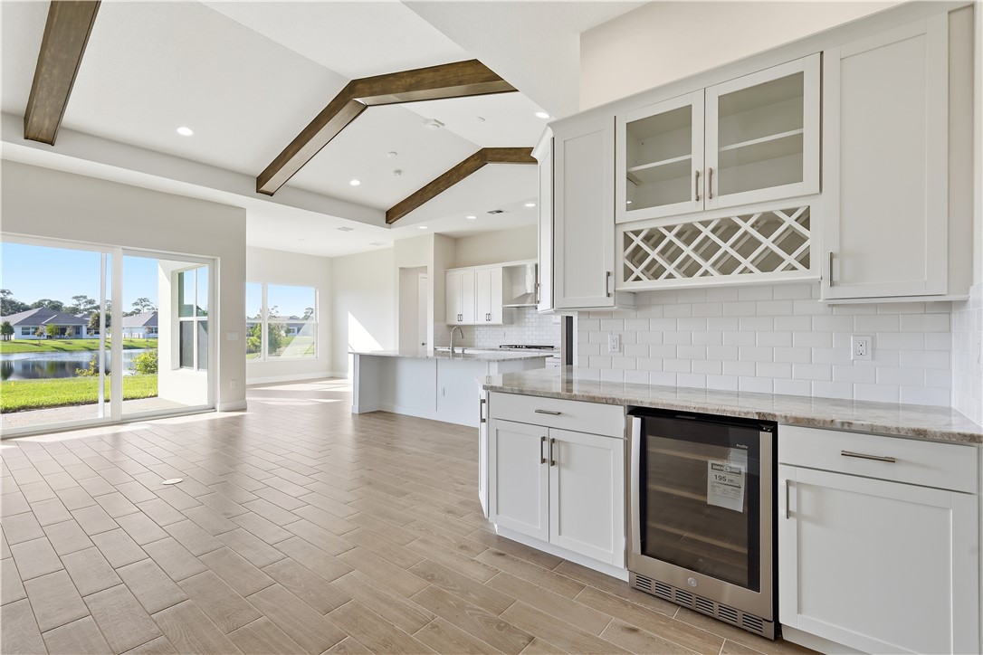 6304 High Pointe Circle Vero Beach, FL 32967 - Photo 4 of 25 a view of a kitchen with a sink and dishwasher with wooden floor