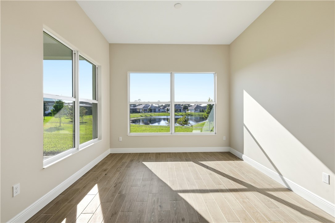 6304 High Pointe Circle Vero Beach, FL 32967 - Photo 10 of 25 a view of an empty room with wooden floor and a window