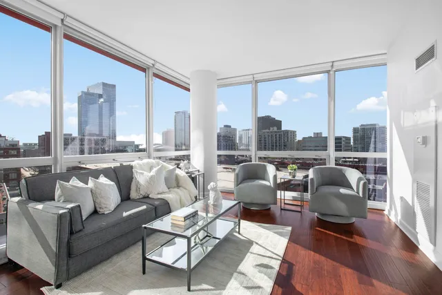 a balcony with furniture and a large window