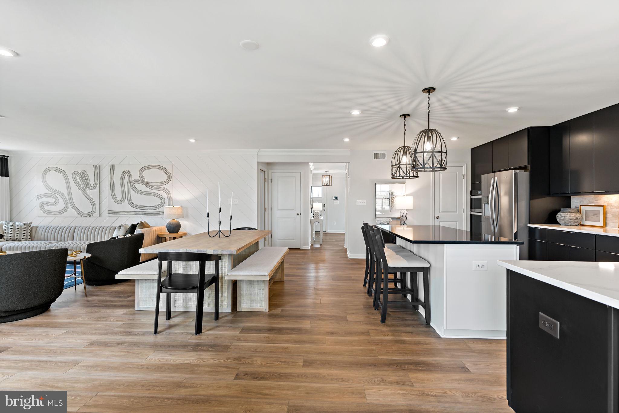 Tbb Tbb Outrigger Road, Unit CARNEGIE Inwood, WV 25428 - Photo 13 of 60 a living room with stainless steel appliances kitchen island granite countertop furniture wooden floor and a kitchen view