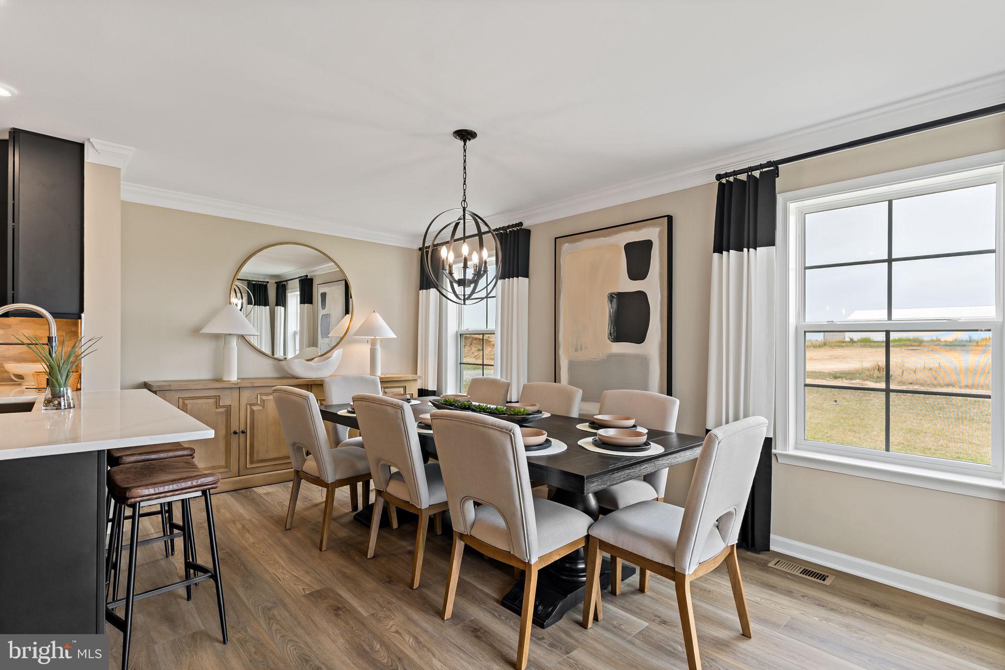 Tbb Tbb Outrigger Road, Unit CARNEGIE Inwood, WV 25428 - Photo 14 of 60 a view of a dining room with furniture window and wooden floor