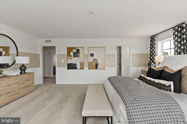 a bedroom with a large bed and a couch