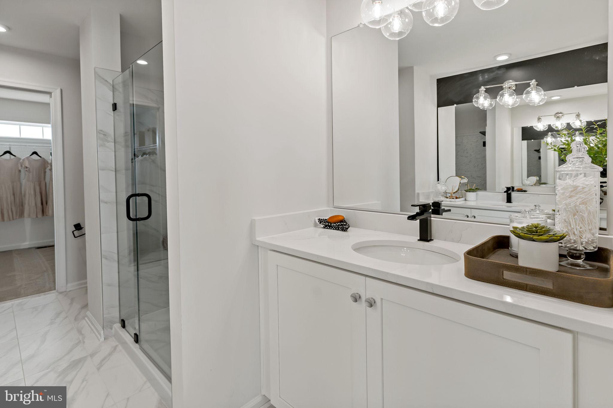 Tbb Tbb Outrigger Road, Unit CARNEGIE Inwood, WV 25428 - Photo 21 of 60 a bathroom with a double vanity sink mirror and shower
