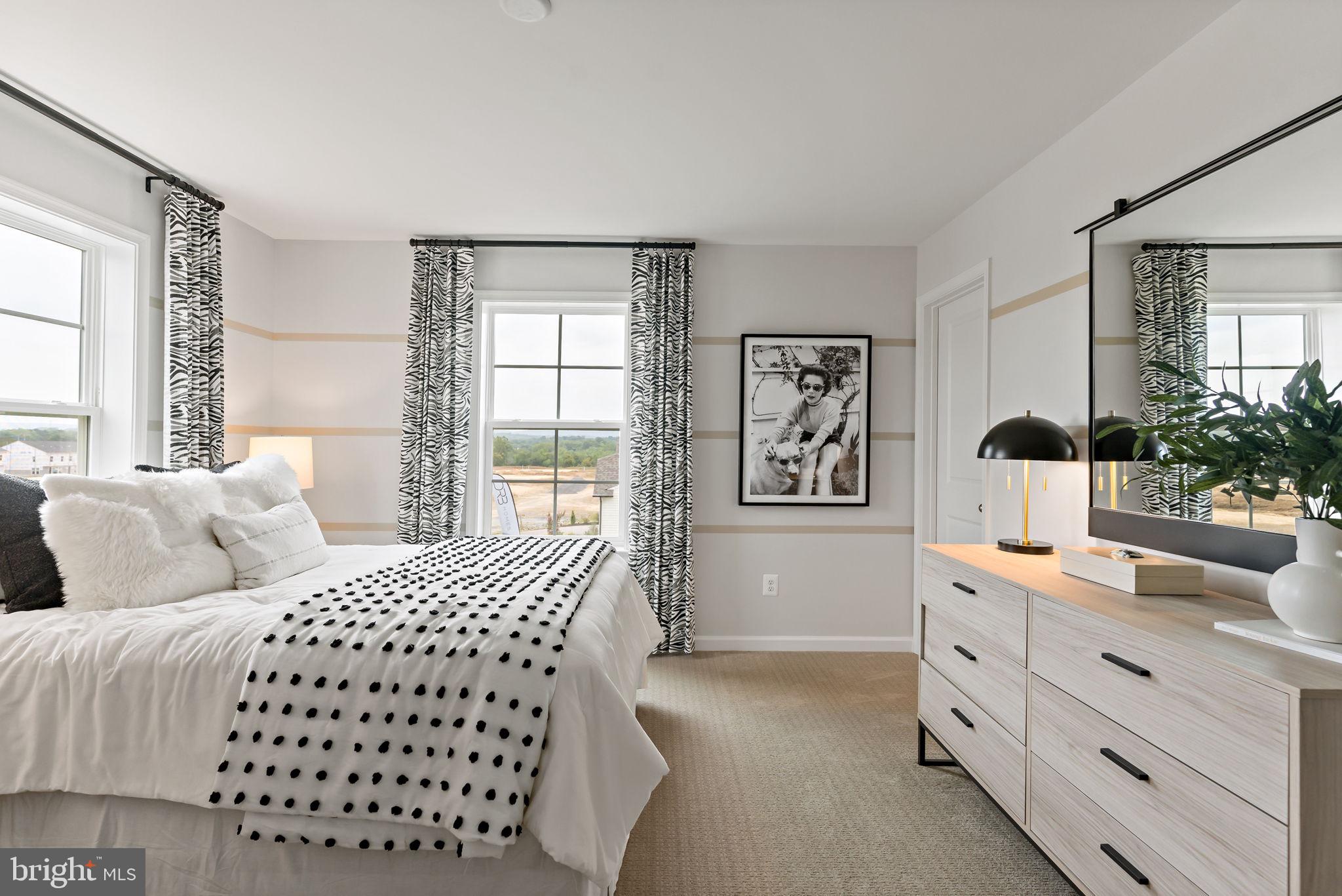 Tbb Tbb Outrigger Road, Unit CARNEGIE Inwood, WV 25428 - Photo 25 of 60 a bedroom with a bed and window with lamp
