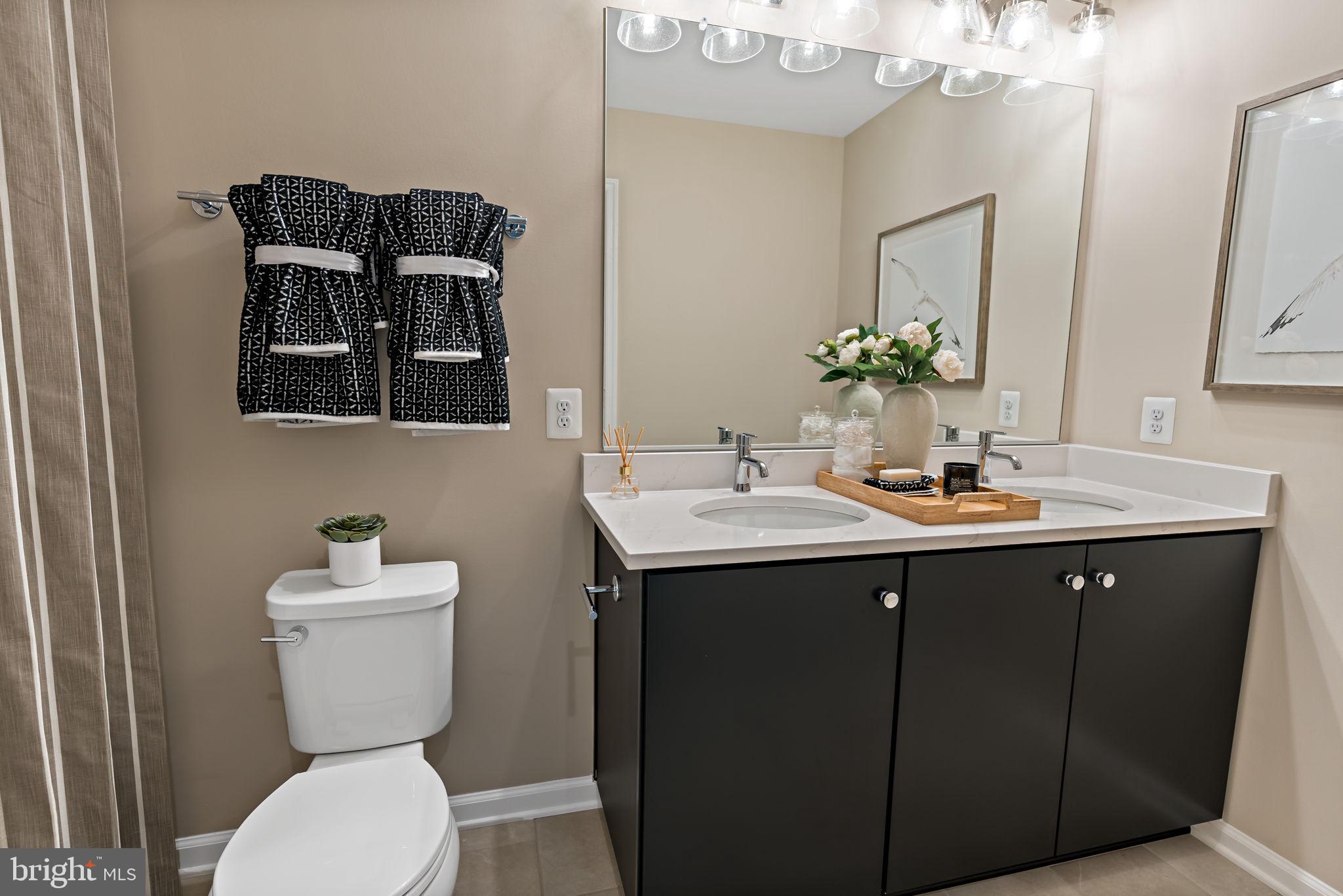Tbb Tbb Outrigger Road, Unit CARNEGIE Inwood, WV 25428 - Photo 27 of 60 a bathroom with a toilet sink and mirror