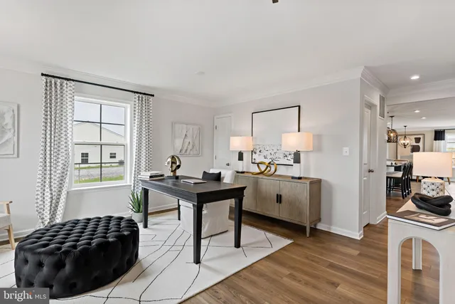 a kitchen with a sink a stove a window and white wooden cabinets