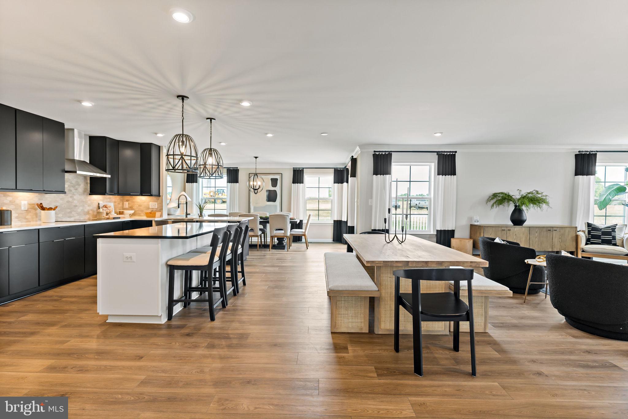 Tbb Tbb Outrigger Road, Unit CARNEGIE Inwood, WV 25428 - Photo 6 of 60 a view of a dining room kitchen with furniture and wooden floor