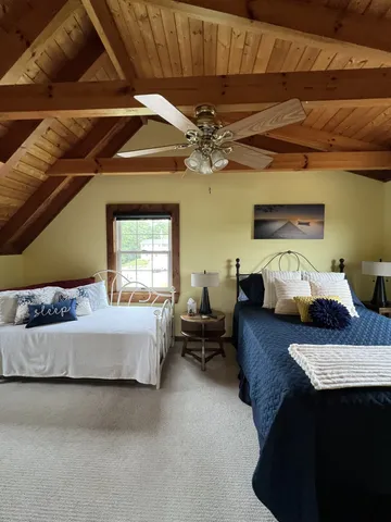 a aerial view of a house with a yard and sitting area