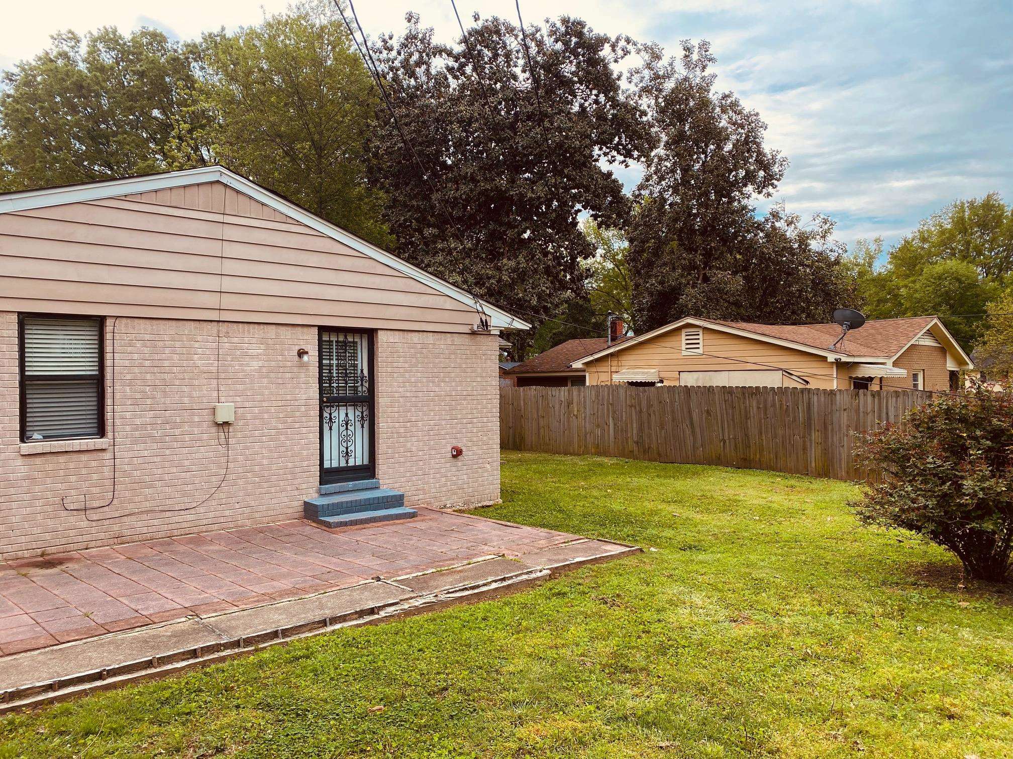 1203 Wilbec Road Memphis, TN 38117 - Photo 17 of 18 a front view of a house with a yard and garage