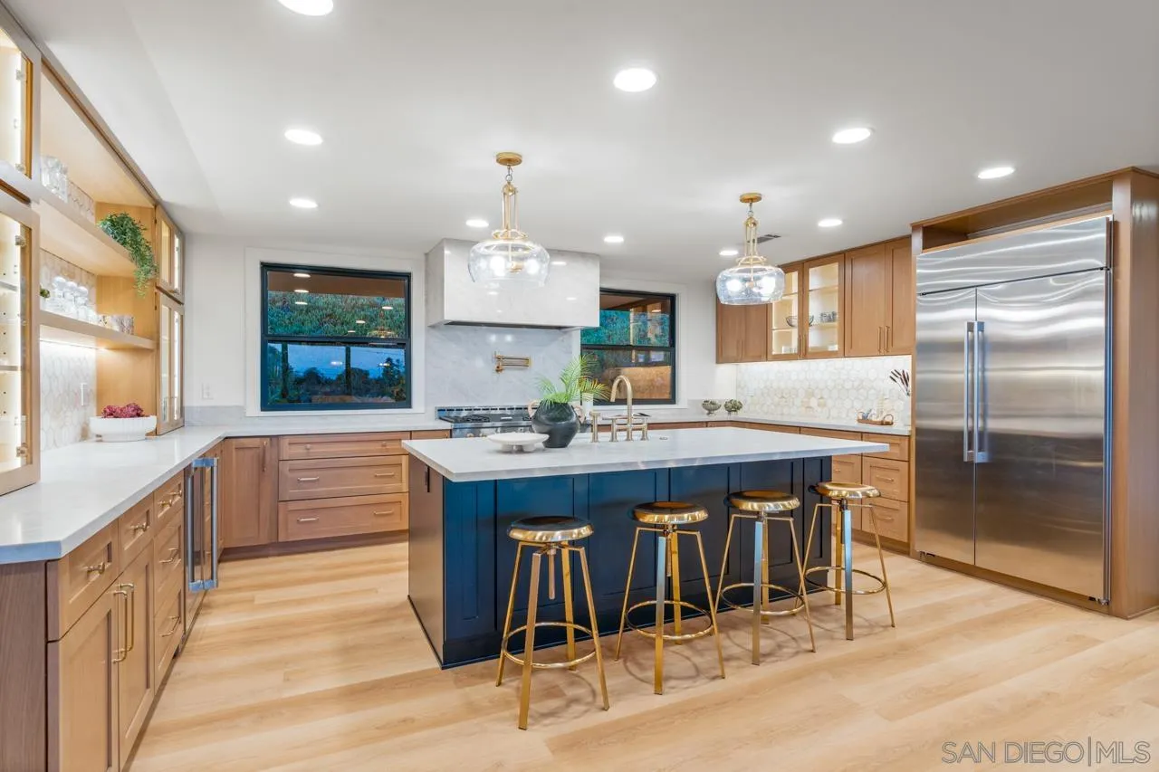 4911 Beaumont Drive La Mesa, CA 91941 - Photo 25 of 74 a kitchen with kitchen island granite countertop wooden cabinets and a center island