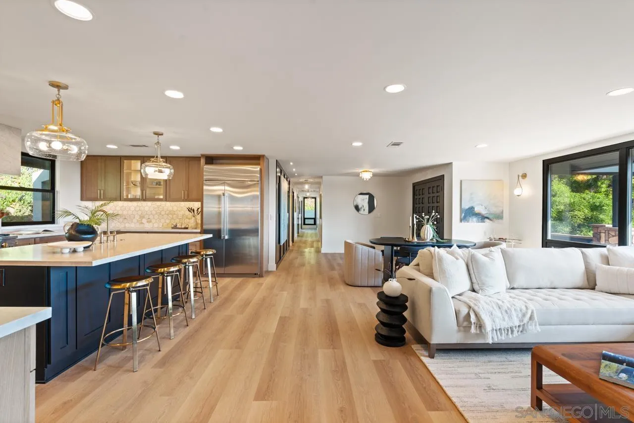 4911 Beaumont Drive La Mesa, CA 91941 - Photo 33 of 74 a large living room with stainless steel appliances kitchen island granite countertop a couch and a view of living room