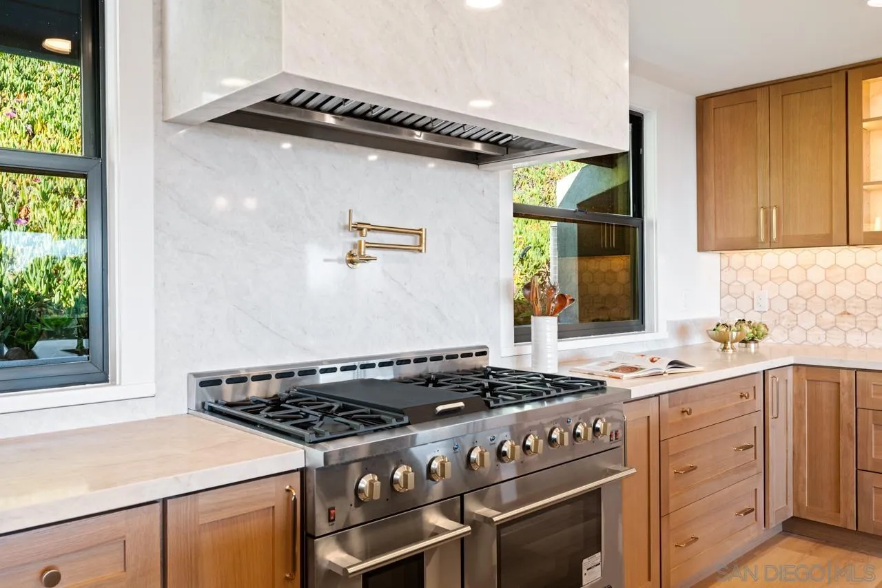 4911 Beaumont Drive La Mesa, CA 91941 - Photo 40 of 74 a kitchen with a stove and a sink
