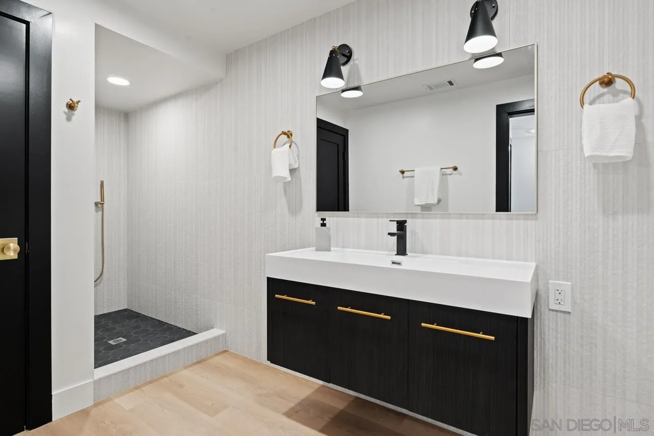 4911 Beaumont Drive La Mesa, CA 91941 - Photo 43 of 74 a spacious bathroom with a sink and a mirror