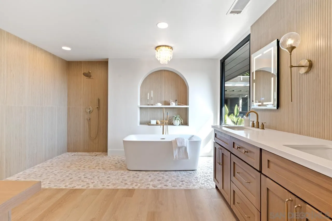 4911 Beaumont Drive La Mesa, CA 91941 - Photo 50 of 74 a spacious bathroom with a sink double vanity and a mirror