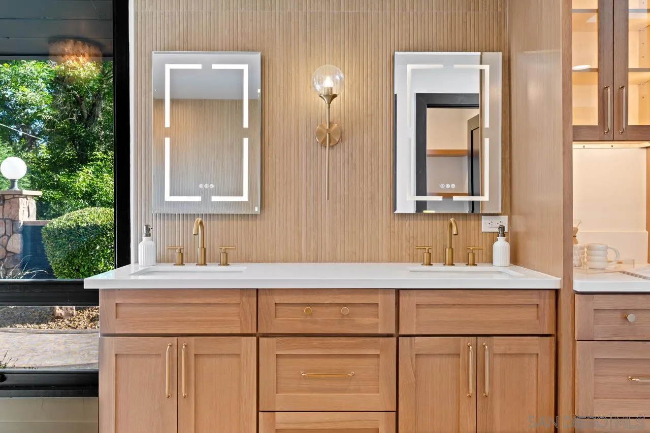 4911 Beaumont Drive La Mesa, CA 91941 - Photo 52 of 74 a bathroom with a sink and a mirror