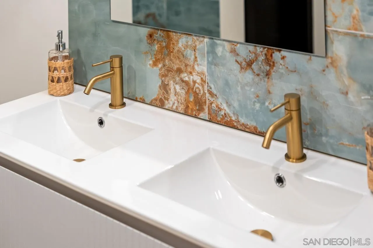 4911 Beaumont Drive La Mesa, CA 91941 - Photo 63 of 74 a bathroom with a sink and a mirror