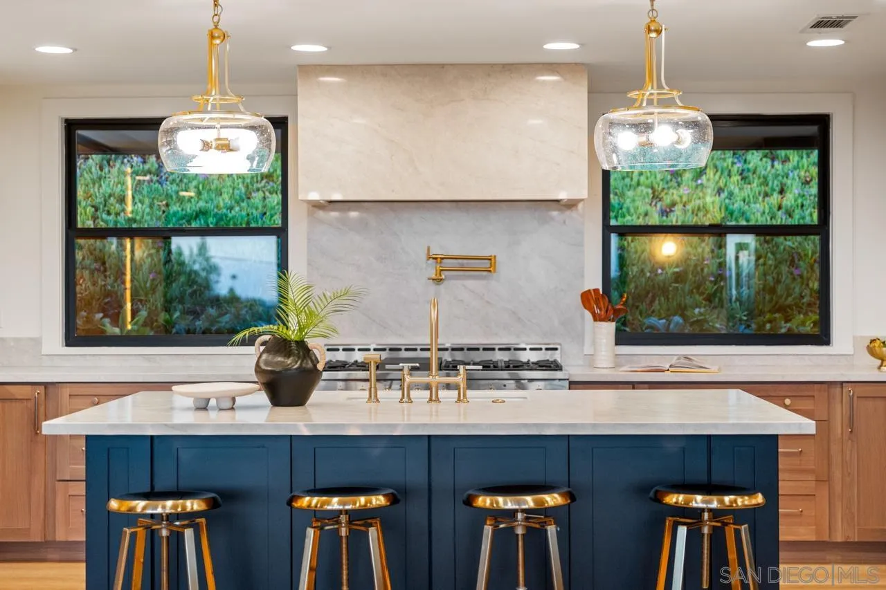 4911 Beaumont Drive La Mesa, CA 91941 - Photo 67 of 74 a kitchen with stainless steel appliances a table and chairs in it