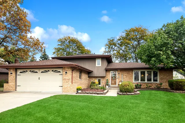 a front view of a house with a yard garage and outdoor seating