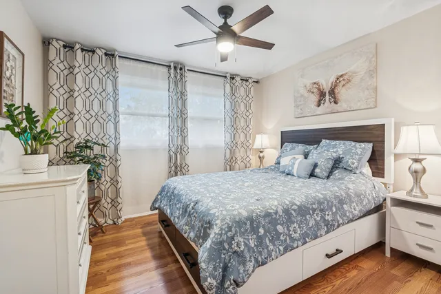 a bedroom with a large bed and a chandelier