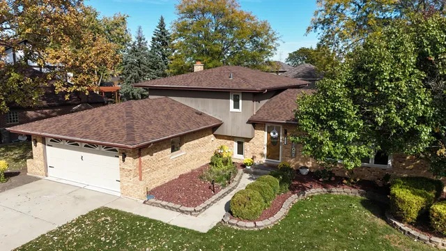 a view of a house with a yard and sitting area