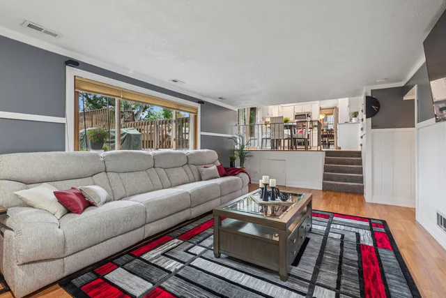 a living room with furniture fireplace and a large window