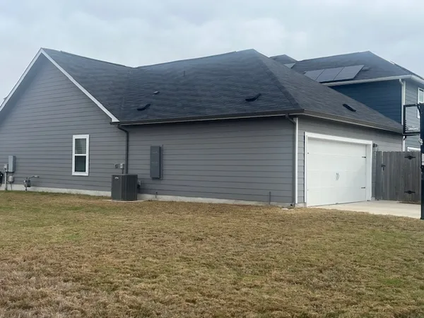 a kitchen with granite countertop wooden cabinets stainless steel appliances and a window