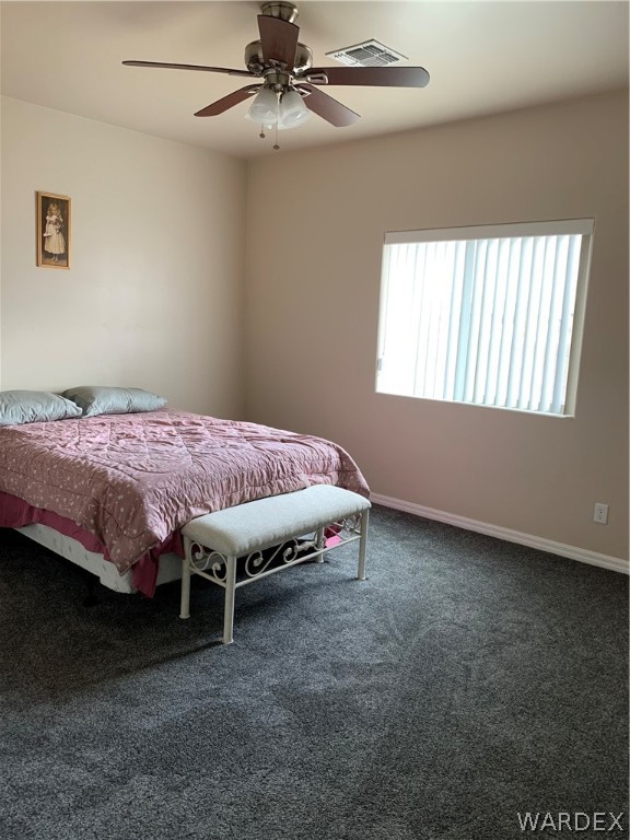 3574 North Kenneth Road Kingman, AZ 86409 - Photo 11 of 20 a bed room with a bed and a chandelier