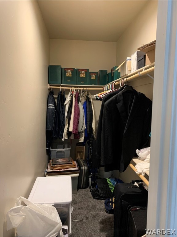 3574 North Kenneth Road Kingman, AZ 86409 - Photo 12 of 20 a view of walk in closet with clothes and shoes