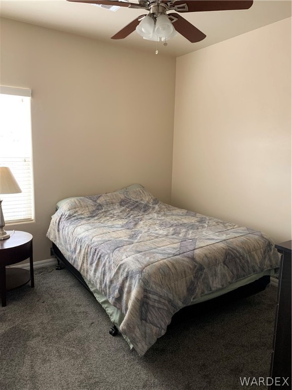 3574 North Kenneth Road Kingman, AZ 86409 - Photo 14 of 20 a bed sitting in a bedroom next to a window