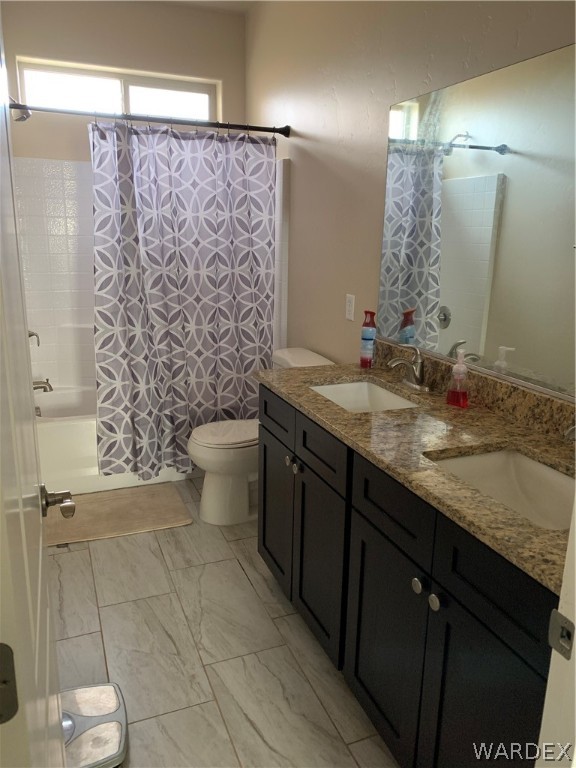 3574 North Kenneth Road Kingman, AZ 86409 - Photo 15 of 20 a bathroom with a granite countertop sink a toilet and a mirror