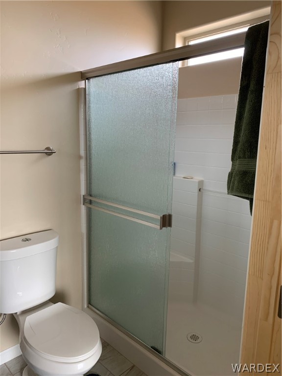 3574 North Kenneth Road Kingman, AZ 86409 - Photo 16 of 20 a white toilet sitting next to a shower