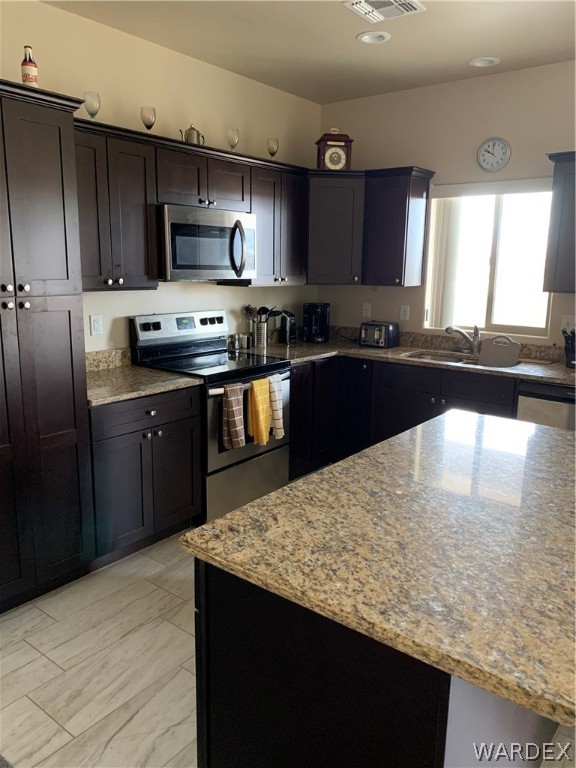 3574 North Kenneth Road Kingman, AZ 86409 - Photo 9 of 20 a kitchen with stainless steel appliances granite countertop a sink stove and refrigerator