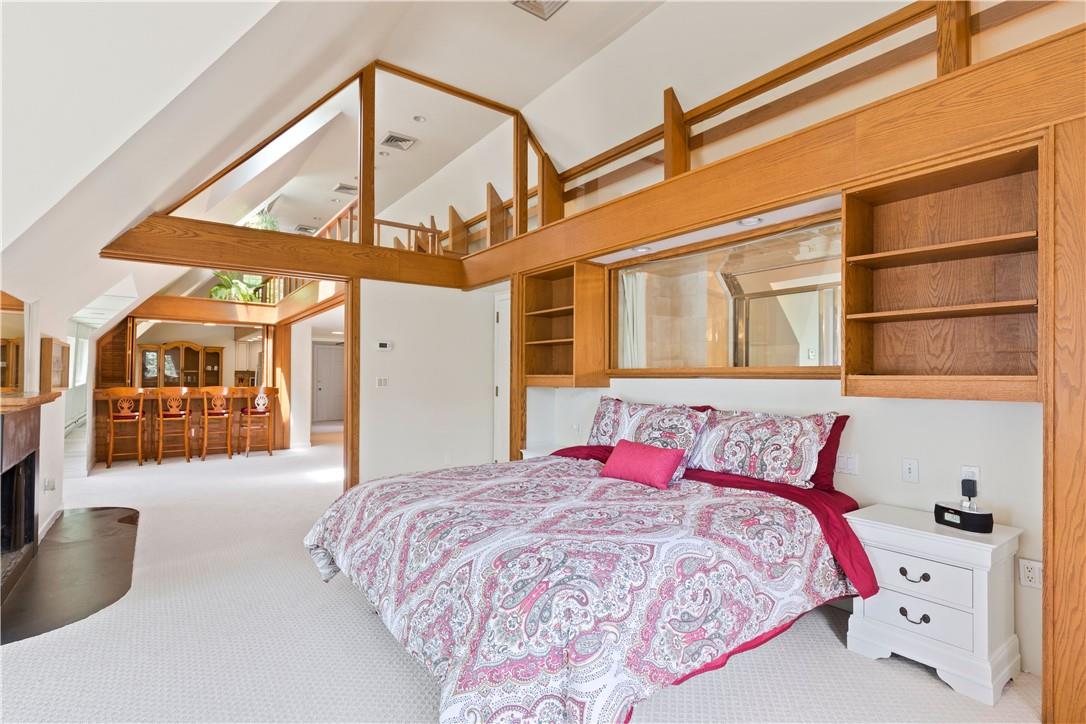 6 Shore Road Rye, NY 10580 - Photo 27 of 36 3rd Floor Bedroom with fireplace and view of counter seating off the Kitchen