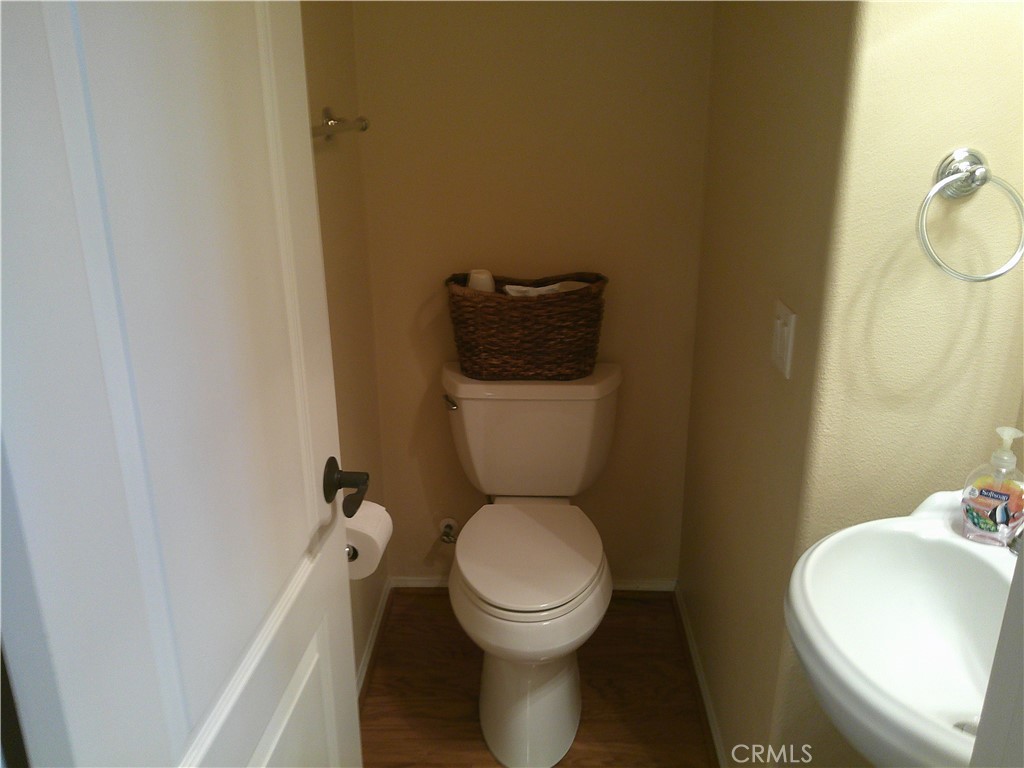 14 Durlston Way Ladera Ranch, CA 92694 - Photo 21 of 38 a white toilet sitting next to a bathroom sink and a mirror