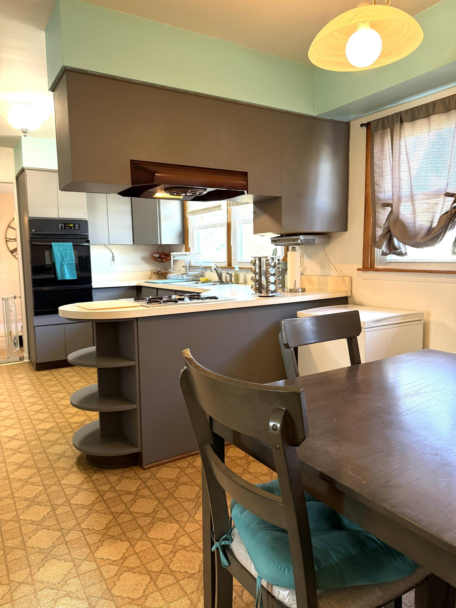 5451 Marcella Road Merrillville, IN 46410 - Photo 13 of 24 a kitchen with a table chairs stove and cabinets