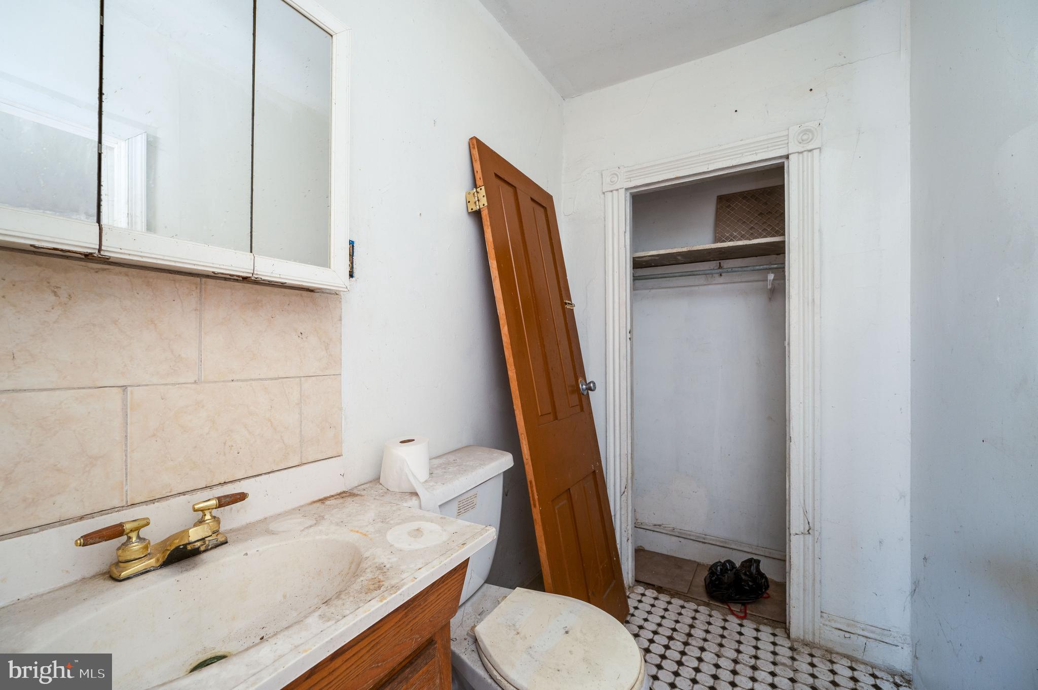 233 Hudson Street Reading, PA 19601 - Photo 18 of 27 a bathroom with a sink a toilet and a mirror