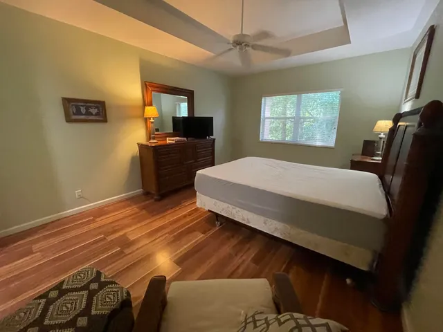 a bedroom with a bed and a television